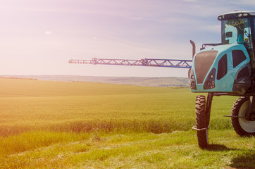Agricultural sprayers, spray chemicals on young wheat.