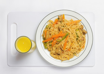 Top View Spaghetti with Chicken and sauce in dish with a Glass of  Juice