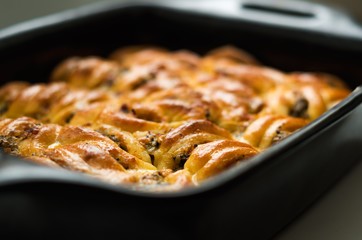Mushroom casserole with cheese in a ceramic bowl.