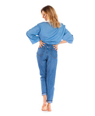 Young woman in blue jeans standing isolated on a white background