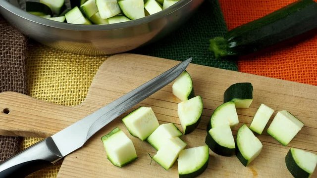 Healthy chopped zucchini on a cutting board with knife