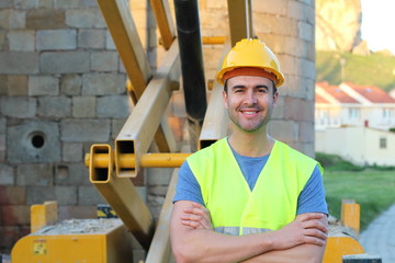 Muscular young construction worker smiling