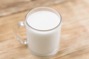 Obraz na płótnie Canvas Glass kefir (milk) on a wooden background. The concept of diet, weight loss.