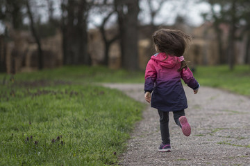 Fototapeta premium Little girl having fun, running in park