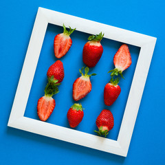 Minimalism. Strawberry martix. Masterpiece in wooden frame. Top view. Flat lay.