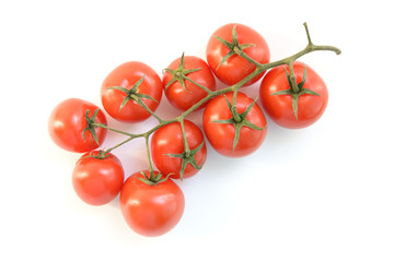 Natural-looking tomatoes on white background. Selective focus.