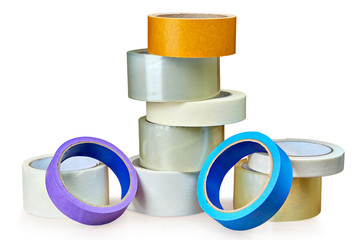 Different rolls of duct tape lie on table,  white background.