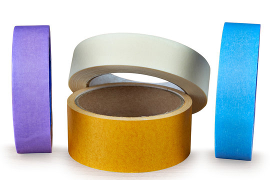 Several multi-colored rolls of adhesive tape on an white background.