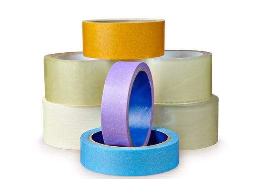 Pile of adhesive tape lies on table,  white background.