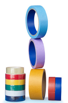 Multi-colored rollers of adhesive tape on  white background.