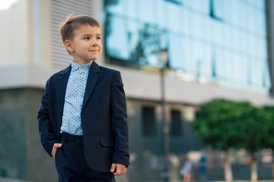 Portrait boy in classic dark blue business suit