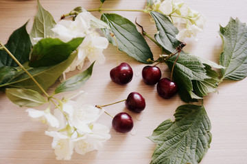 cherries and flowers on the table