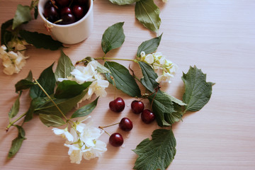 cherry in the cup and flowers on the table