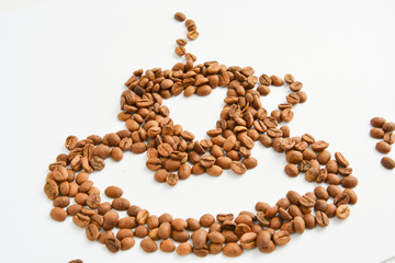 cup of coffee and a saucer made from coffee beans on a light background