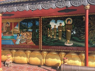Religious colorful 3-dimensional relics on the walls of Wat Preah Prom Rath Temple in Siem Reap, Cambodia.  Relief paintings depicting the life of the Buddha