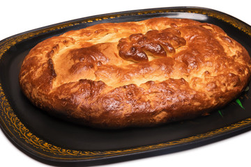 Closed pie with a snapper on a tray isolated on a white background