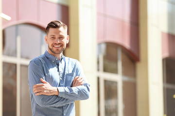 Portrait of young man in stylish outfit outdoors