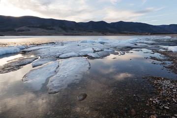 The white ice floes on the blue water of the lake. Lake Baikal in spring