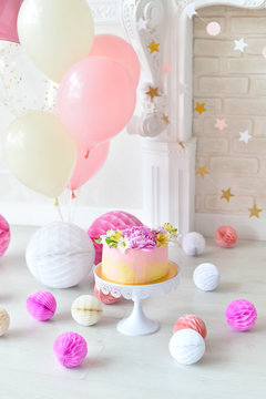 Decorations for holiday party. A lot of balloons pink and white colors. Cake for holiday party. 