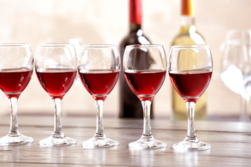 Glasses with delicious red wine on table
