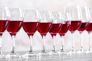 Glasses with delicious red wine on table