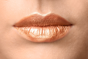 Beautiful young model with creative lips makeup, closeup