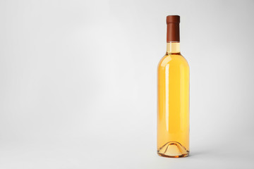Bottle of expensive wine on white background