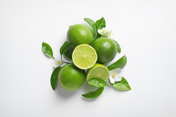 Composition with fresh ripe limes on white background, top view