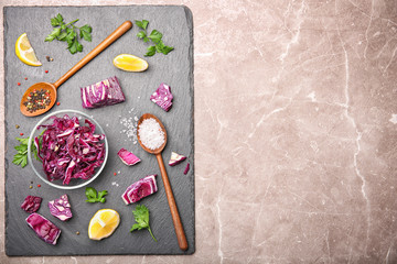Slate plate with chopped red cabbage and different ingredients, top view