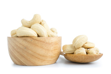 cashew nuts in wood cup isolated on white