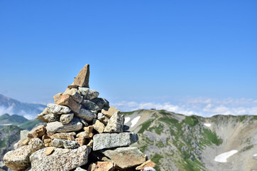 A blue sky and cairn
