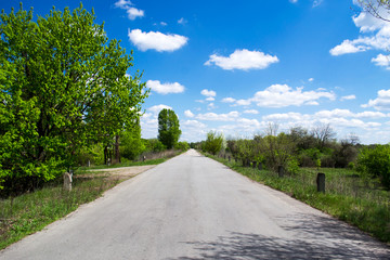 Road going into the distance. Sky with clouds. Summer sunny day. Travel