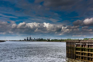 Fototapeten dramatic sky above the port of Antwerp © Koen