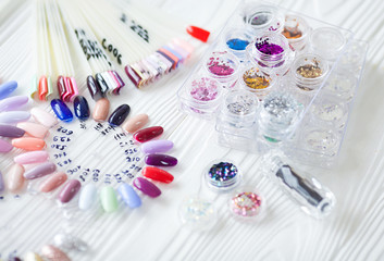 Table full of manicure utensils, manicure tools, nail polish colours on palette. Nails art...