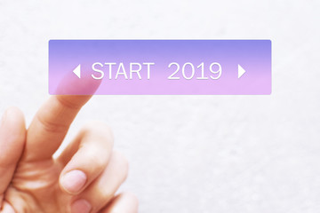 Finger pressing transparent 2019 start button on white background with copy space for text or image. Concept of new year of  two thousand nineteen.