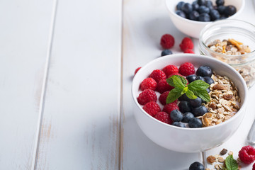 Smoothie bowl with yogurt, fresh berries and cereal. Raw ingredients for nice day