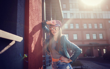 Cheerful young woman in sunglasses and hat. Beautiful female model with long hair.