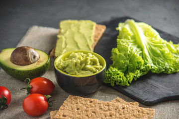 Mexican cold appetizer made of pureed avocado pulp with bread and vegetables. Concept healthy vegetarian Breakfast