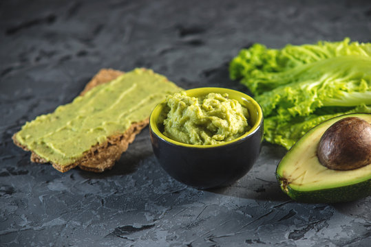 Mexican cold appetizer made of pureed avocado pulp with bread and vegetables. Concept green healthy vegetarian Breakfast