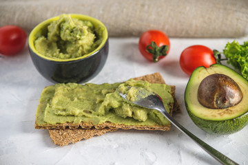 Mexican cold appetizer made of pureed avocado pulp with bread and vegetables. Concept healthy vegetarian Breakfast