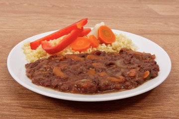 Azuki with vegetables on steam and bulgur on a table