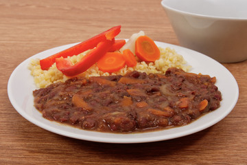 Azuki with vegetables on steam and bulgur on a table