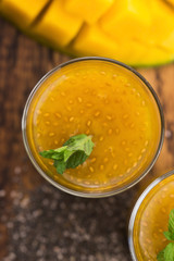 Fresh mango smoothie in glass with chia seeds