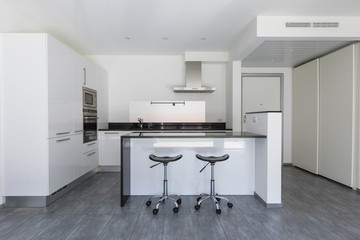 Modern white kitchen with island and stools