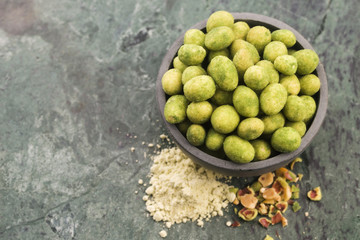 Pile of wasabi coated peanuts in bowl