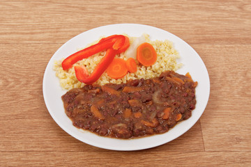 Azuki with vegetables on steam and bulgur on a table