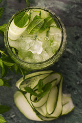 Refreshing detox cocktail with cucumber, mint and ice in glass