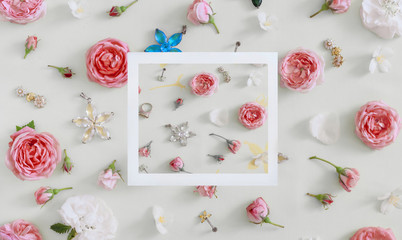 Obraz na płótnie Canvas jewelry for women, flowers on a light colored background