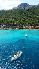 Aerial drone bird's eye photo of tropical paradise island beach with emerald crystal clear waters