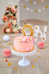 One year birthday decorations. Decorations for holiday party. A lot of balloons yellow and pink colors. Cake for birthday party. 